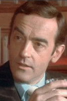 Peter Forbes-Robertson as Newscaster