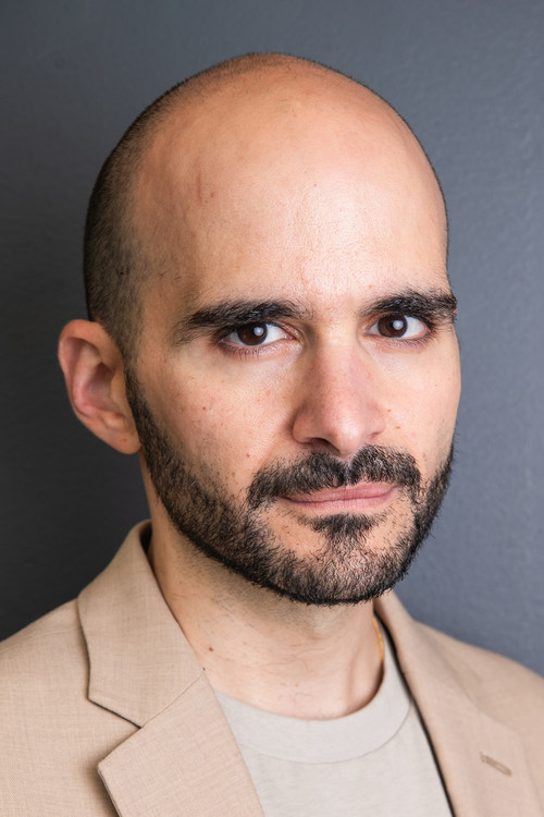 Cyril Aris as Man in Street