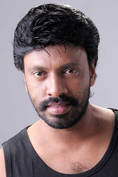 Harikumar as One among group dancers in a song “Naan Autokaaran”