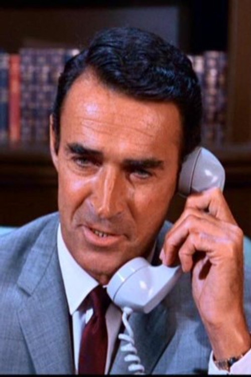 Albert Carrier as Travel Agent