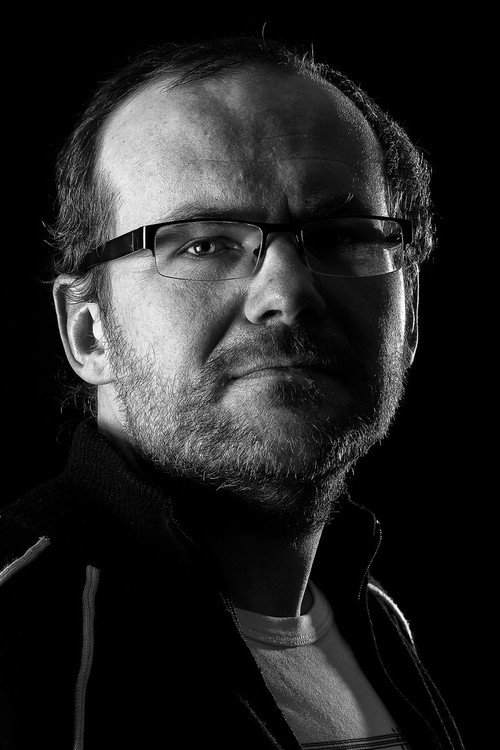 Arko Okk as Man With a White Hat in the Cyclecar Driven by Juris Pakalninsh