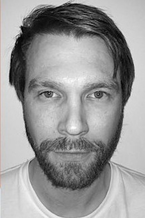 Michael Homick as Kwei (Suit)