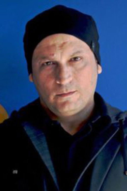 Akis Gourzoulidis as Christos Interrogator