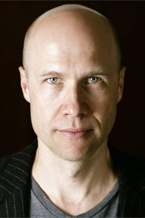 Shane Bartle as Father Carhill