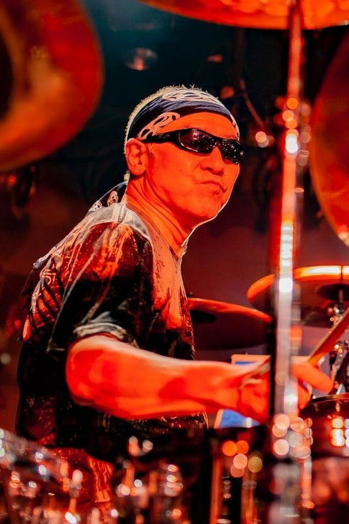 Hirotsugu Homma as Drums