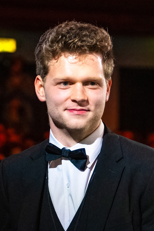 Sam Santrock as The Officiant