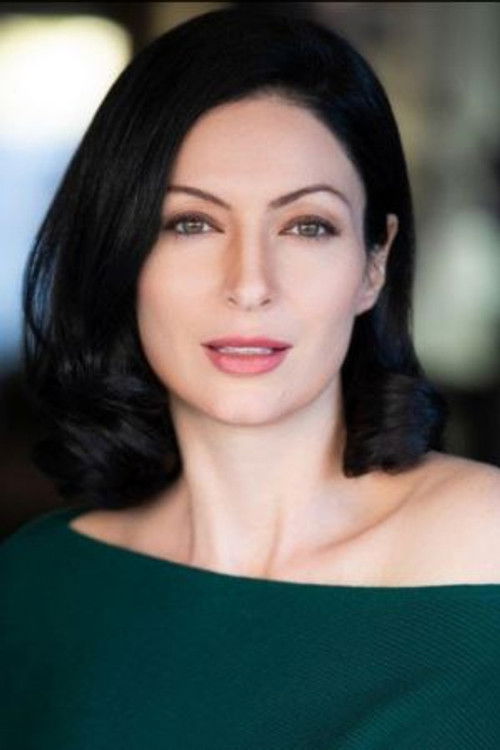 Landa Morland as Russian News Anchor