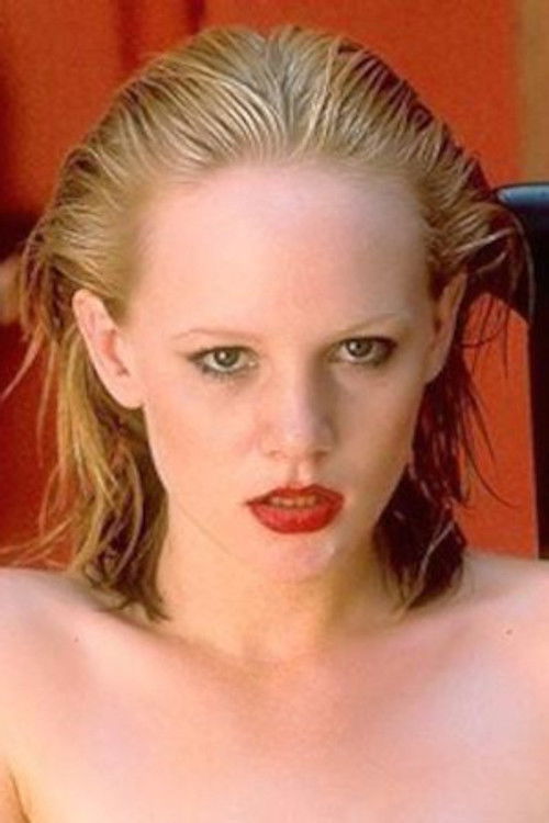 Tami Graph as Blonde Near Orange Chair (archive footage)