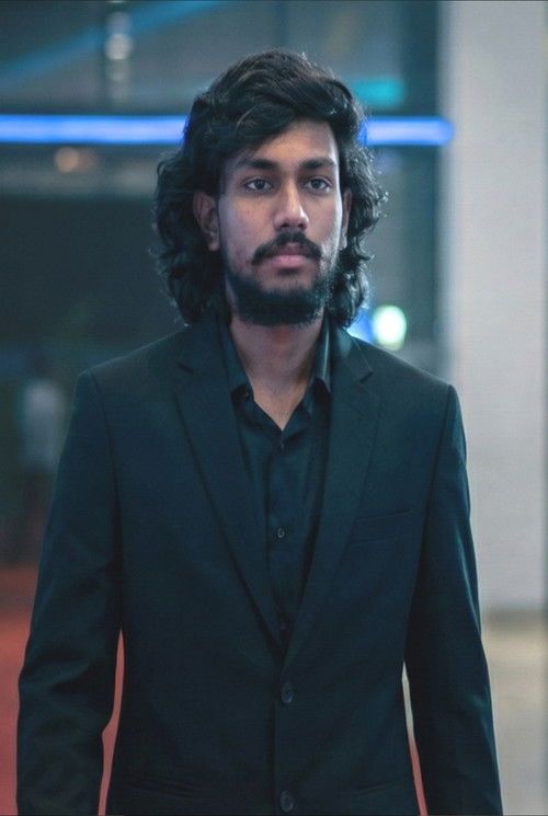 Kesava Chandra as Agenetos / The Raconteur / Brahma Vardha