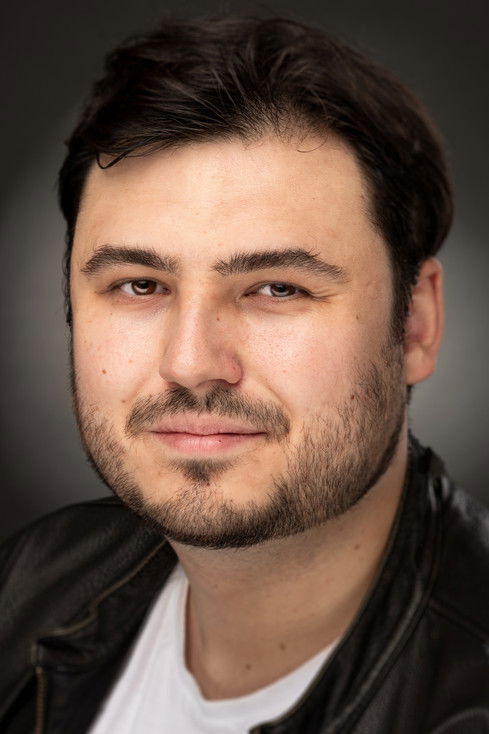 John Reynolds as Man in Blue Suit