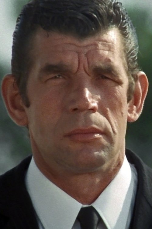 Michel Constantin as Greg, the henchman