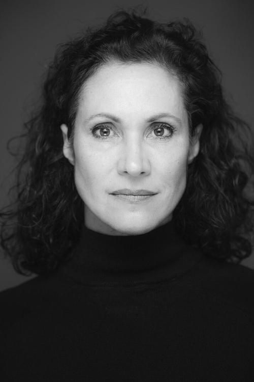 Justine del Corte as Mrs. Brecht