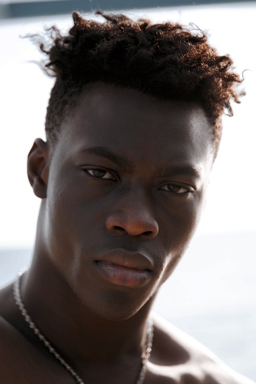 Emmanuel Elozieuwa as Kosmas