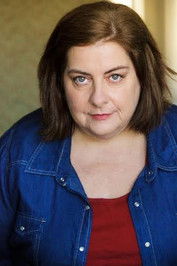 Polly Humphreys as registrar brenda