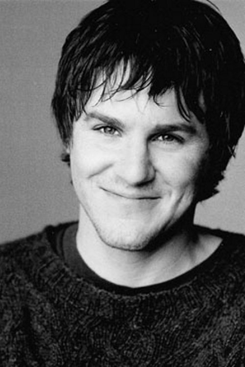 Mark Ballou as Tom Hollister