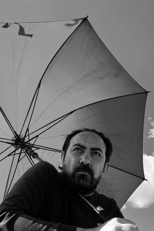 Bangen Ali as The Man with Cigarette