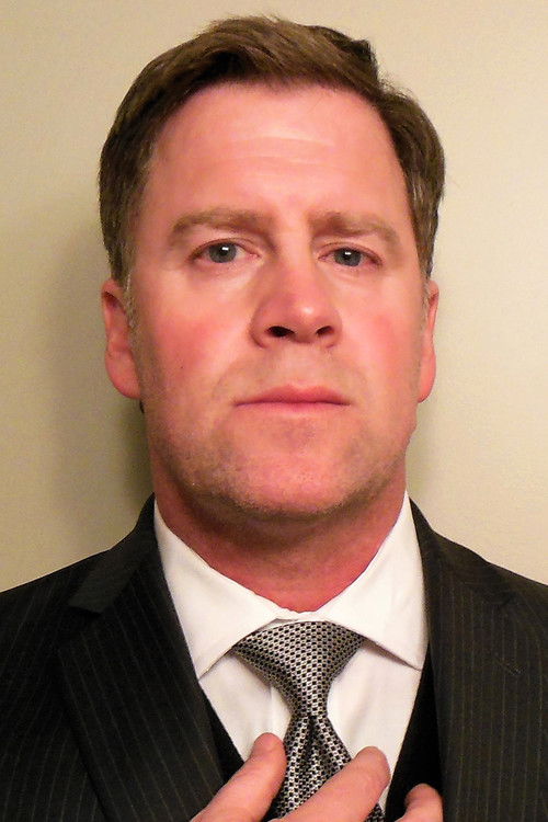 Gordon Rix as Corporate Executive