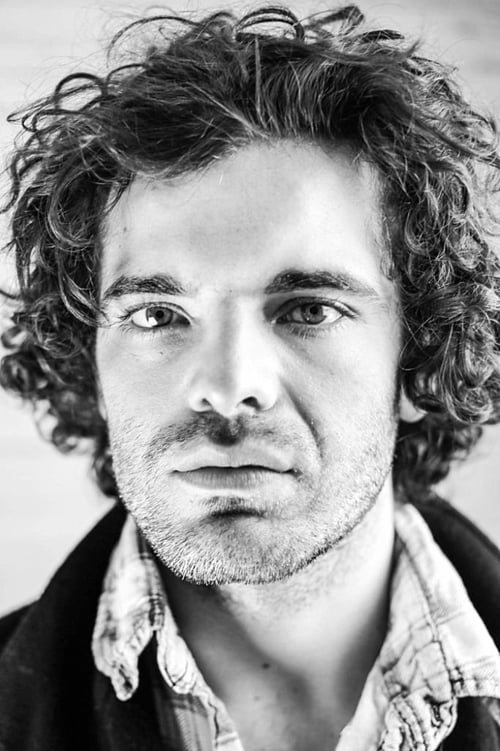 Fionn Cox-Davies as Masked Mob Member