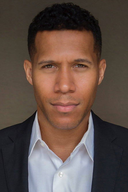 Lodric D. Collins as Man at Press Conference