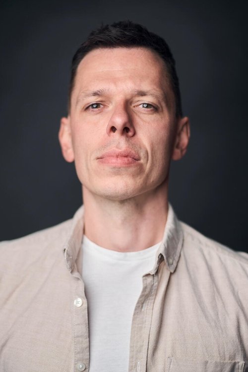 Lee Comley as English Newscaster 2