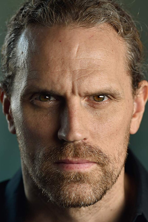 Travis Johns as Riley