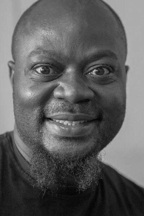 Major Assé as JB, l'ami camerounais