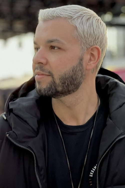 Joel Junior as Stranger in a suit