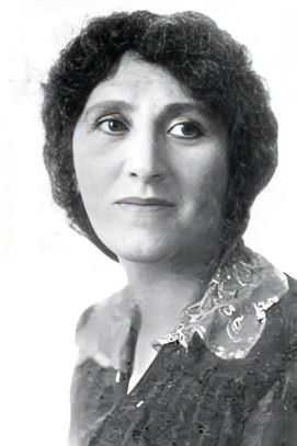 Florence Natol as Mrs. Scroogles